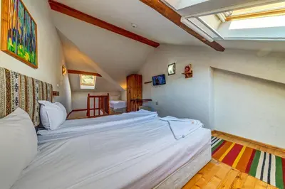 a bedroom with two large beds in a room at Hotel Mursal in Yagodina