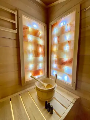 a corner of a sauna with a bowl and windows at Hotel Mursal in Yagodina
