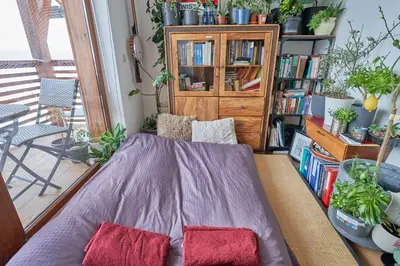 a room with a bed and a book shelf with books at Panoramic 2 Bedroom Cabin Retreat Japanese Style in Bansko