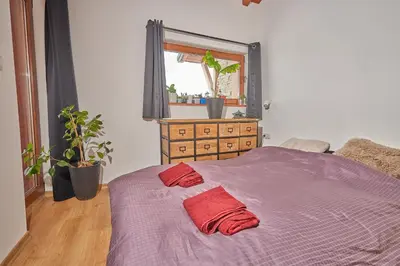 a bedroom with a bed with two red pillows on it at Panoramic 2 Bedroom Cabin Retreat Japanese Style in Bansko