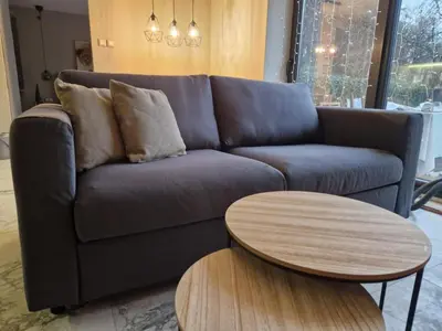 a living room with a couch and a table at Daisy Garden by the Church in Razlog