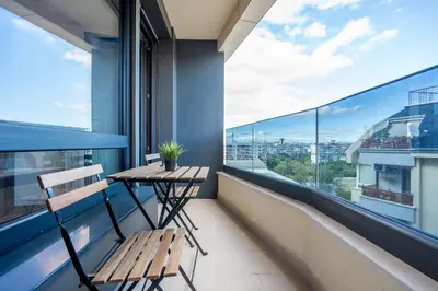 a balcony with a table and chairs on a building at Palitra Studio in Sofia