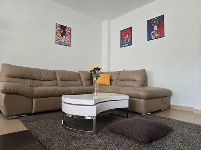 a living room with a couch and a coffee table at Family Suite in Sofia