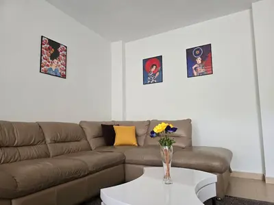 a living room with a couch and a table at Family Suite in Sofia