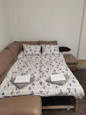 a bed with two napkins on top of it at Family Suite in Sofia