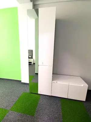 an empty room with a bed and green carpet at Ubis Hotel in Krumovo