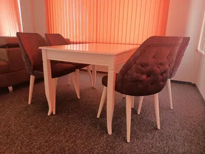 a table with two chairs and a white table and a table and chairs at Ubis Hotel in Krumovo