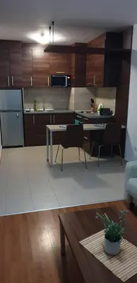 a kitchen and living room with a table and chairs at Apartments Belvedere B303 in Bansko