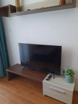 a living room with a large flat screen tv at Apartments Belvedere B303 in Bansko