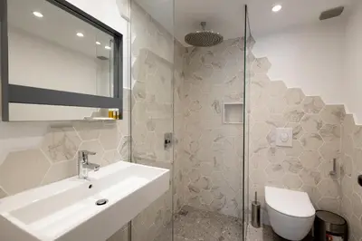 a bathroom with a sink and a shower at Luxury studio 12-4 in Plovdiv