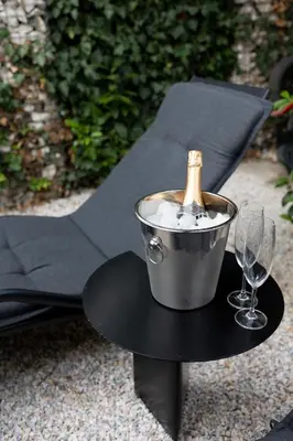 a bottle of champagne in a bucket on a table with wine glasses at Luxury studio 12-4 in Plovdiv