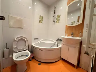 a bathroom with a toilet and a tub and a sink at Cozy flat in central Sofia in Sofia