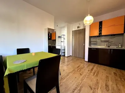 a kitchen and dining room with a green table and chairs at Cozy flat in central Sofia in Sofia