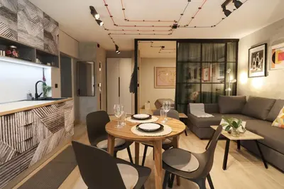 a living room with a table and chairs and a couch at NEW Oasis in the heart of Sofia in Sofia
