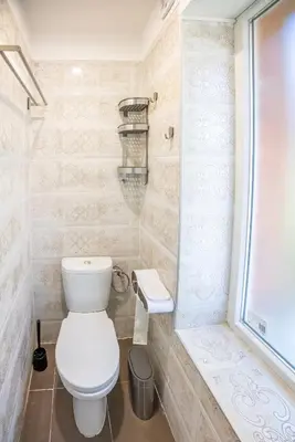 a small bathroom with a toilet and a shower at Ukulele Place in Sofia