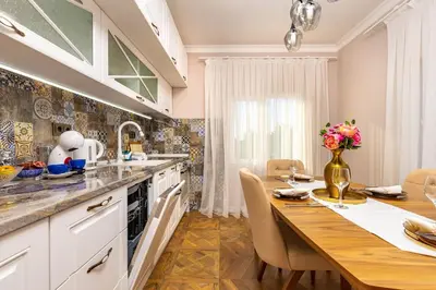 a kitchen with a wooden table and a dining room at Casa Marincheshki in Orizari - 6км to Plovdiv in Orizari