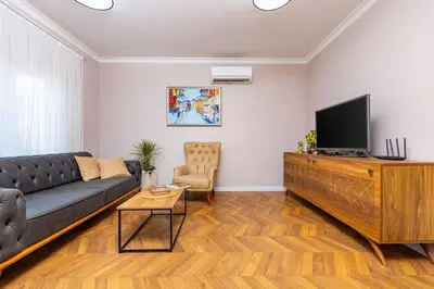 a living room with a couch and a flat screen tv at Casa Marincheshki in Orizari - 6км to Plovdiv in Orizari