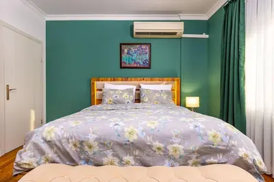 a bedroom with a bed with a blue wall at Casa Marincheshki in Orizari - 6км to Plovdiv in Orizari
