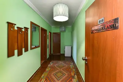 a hallway with green walls and a sign on the door at Cedar Lodge III - One BDRM Flat B18 in Bansko