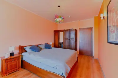 a bedroom with a bed with blue pillows on it at Cedar Lodge III - One BDRM Flat B18 in Bansko