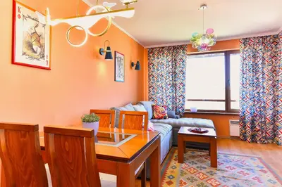 a living room with a couch and a table at Cedar Lodge III - One BDRM Flat B18 in Bansko