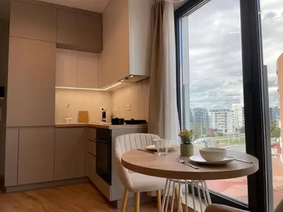 a small kitchen with a table and a large window at Via310 by Cosher in Sofia