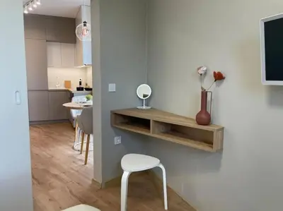 a living room with a chair and a tv on a wall at Via310 by Cosher in Sofia