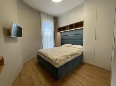 a bedroom with a bed and a flat screen tv at Via310 by Cosher in Sofia