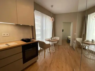 a kitchen with a counter and a table and chairs at Via310 by Cosher in Sofia