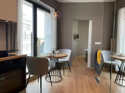 a kitchen with a table and chairs in a room at Via421 by COSHER in Sofia