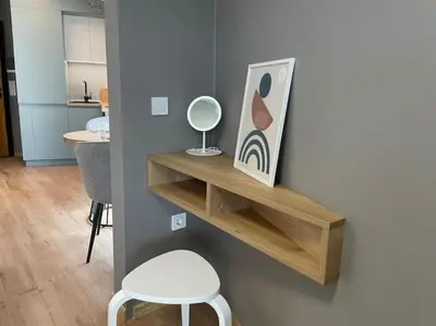 a shelf on a wall with a mirror and a stool at Via421 by COSHER in Sofia