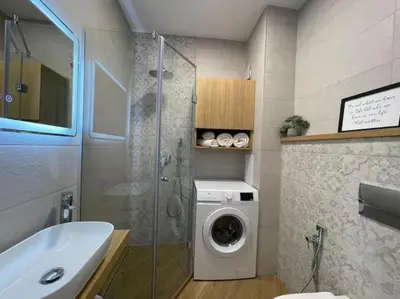 a bathroom with a washing machine and a sink at Via421 by COSHER in Sofia