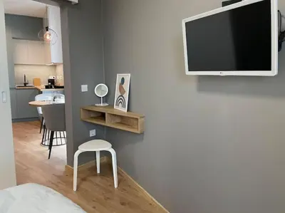 a living room with a television on a wall at Via421 by COSHER in Sofia
