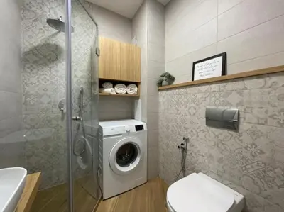 a bathroom with a washing machine and a washer at Via421 by COSHER in Sofia