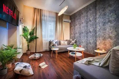 a living room with a couch and a table at Your Spacious Home With Terrace & 3 Acs in Sofia