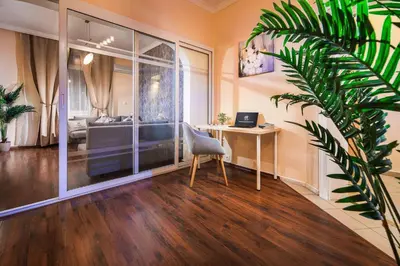 a home office with a desk and a laptop on a table at Your Spacious Home With Terrace & 3 Acs in Sofia
