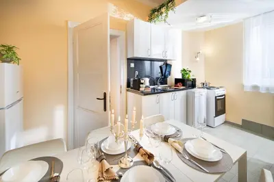 a dining room with a table and a kitchen at Your Spacious Home With Terrace & 3 Acs in Sofia