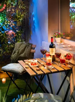 a table with a bottle of wine and wine glasses at Your Spacious Home With Terrace & 3 Acs in Sofia