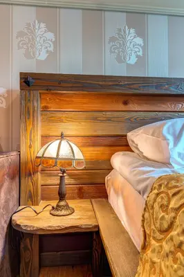 a lamp on a table next to a bed at Cozy and Stylish Studio in Forest Glade by Flat Manаger in Pamporovo