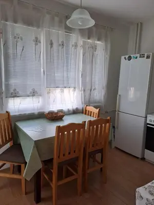 a kitchen with a table and chairs and a refrigerator at LevskiG Studio 10 min from Sofia Airport and city centre in Sofia