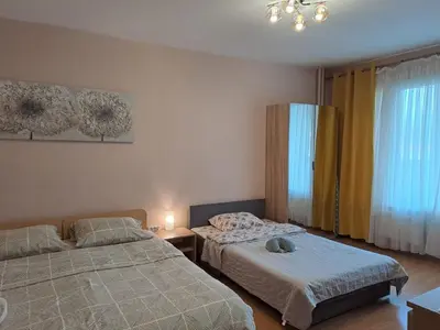 a bedroom with two beds and a window at LevskiG Studio 10 min from Sofia Airport and city centre in Sofia