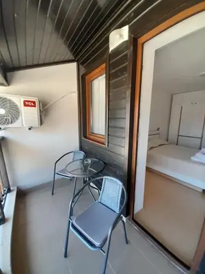 a small table and chair in a small room with a bed at Lux Apartament 4403 near the ski lift in Bansko