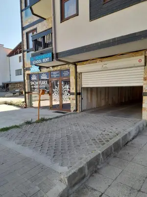 an empty street in front of a building at Lux Apartament 4403 near the ski lift in Bansko