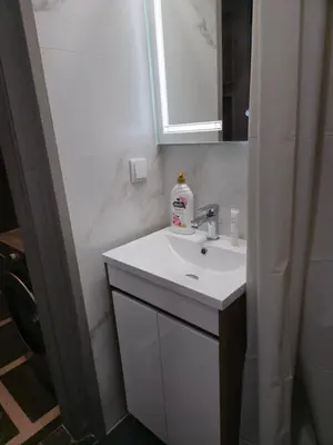 a bathroom with a white sink and a mirror at New Premium COZY apartment in the center next to NDK in Sofia