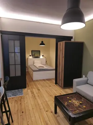 a room with a bed and a couch and a table at New Premium COZY apartment in the center next to NDK in Sofia