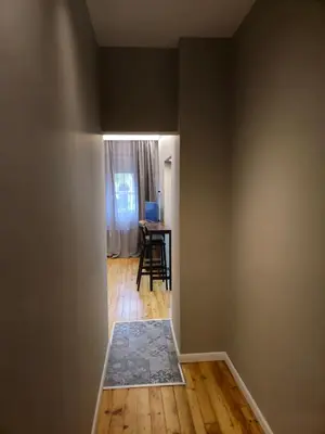 an empty room with a table and a chair at New Premium COZY apartment in the center next to NDK in Sofia