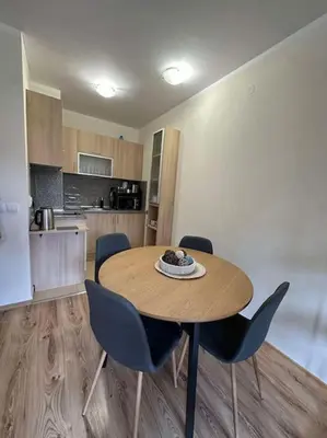 a kitchen with a table and chairs in a room at large apartment in Borovets in Borovets