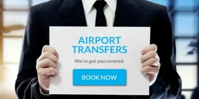 a man in a suit holding a sign that reads airport transfers at Artistic Atelier, Top Center - Vitosha Blvd in Sofia