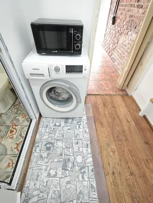 a washing machine with a microwave on top of it at Artistic Atelier, Top Center - Vitosha Blvd in Sofia