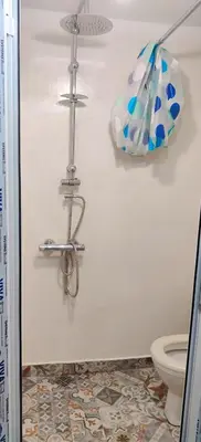 a bathroom with a toilet and a lamp on the wall at Artistic Atelier, Top Center - Vitosha Blvd in Sofia